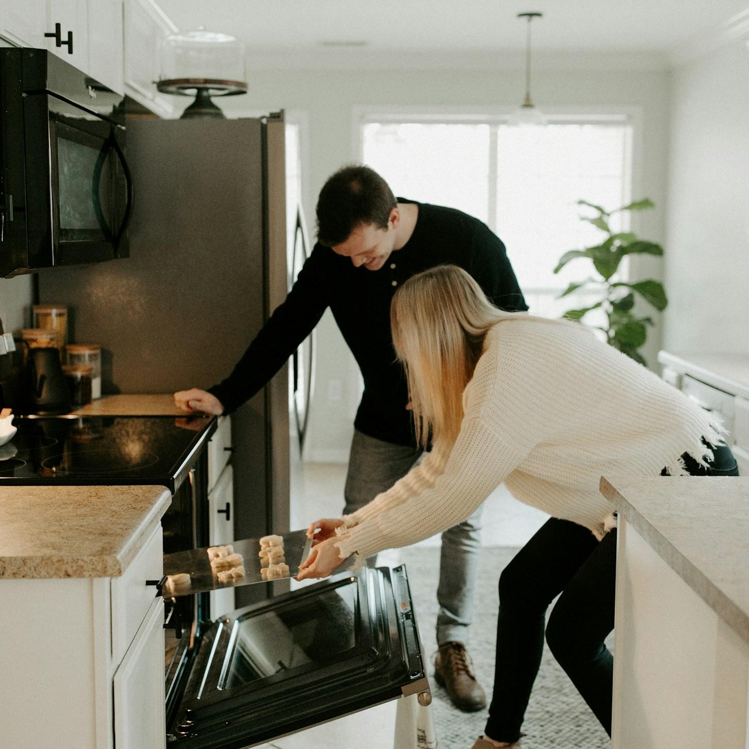 Community members collaborating in a modern kitchen space, sharing recipes and cooking techniques